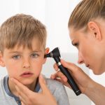 Doctor Examining Boy’s Ear