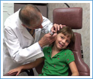 Dr. Rande Lazar checks ear infection in child