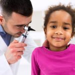 Otolaryngologist examining a kid ear